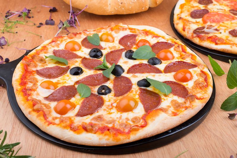 Wood-fired pizza fresh out of the oven at papa gino's